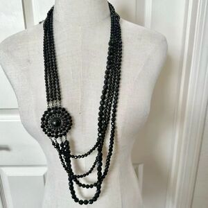 Long multi strand black beaded flower necklace